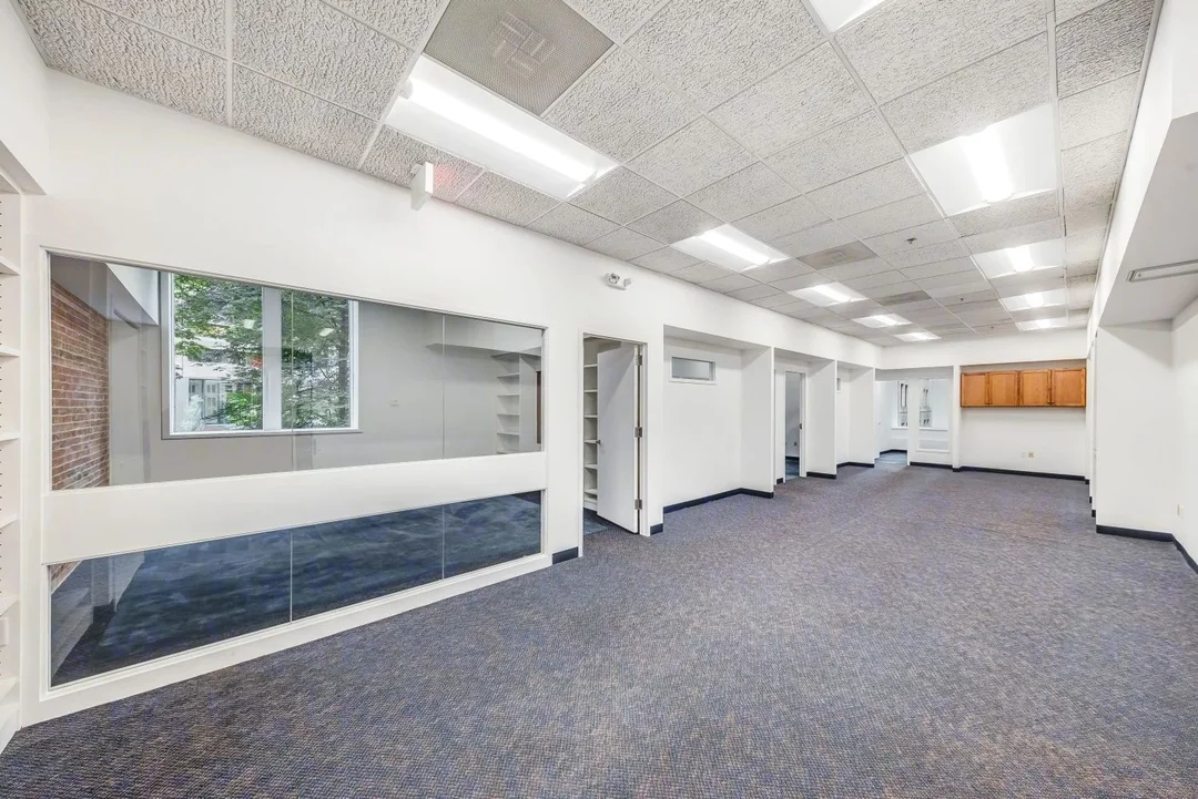 Commercial office suite with private offices, interior windows, and flexible layout potential.