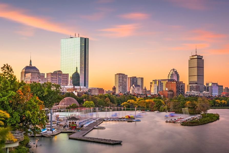 Boston skyline at sunset viewed from the Charles River with city buildings
